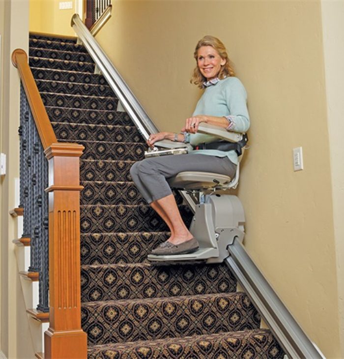 Woman riding stairlift
