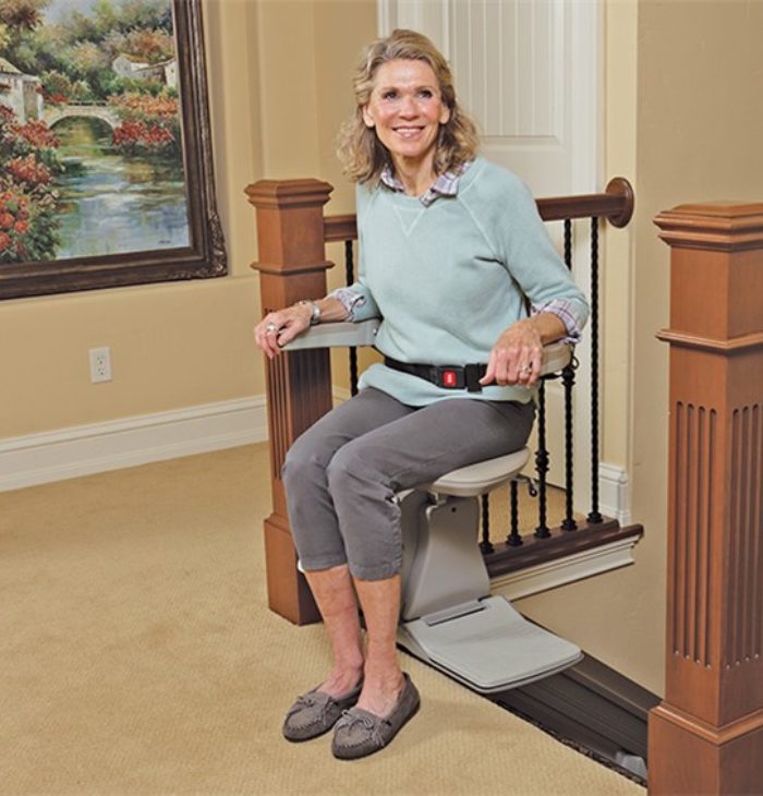 Elderly woman about to ride stairlift