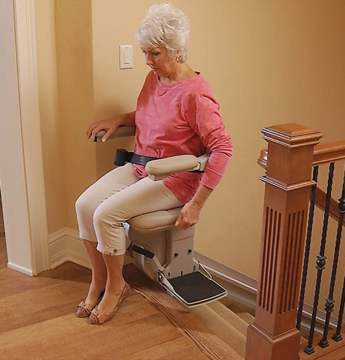 Elderly woman riding bruno elite stairlift
