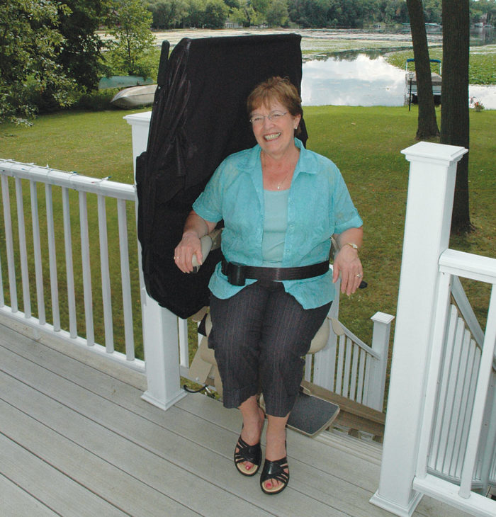 Woman riding bruno elite outdoor stairlift