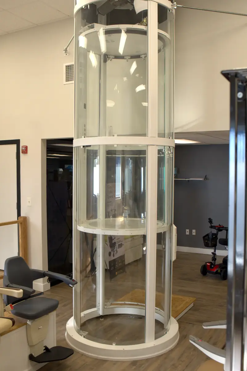 Round glass home elevator on display in the 101 Mobility showroom