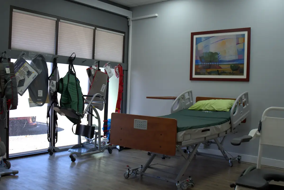 Patient care room with a hospital bed, patient lifts, and slings in the 101 Mobility showroom
